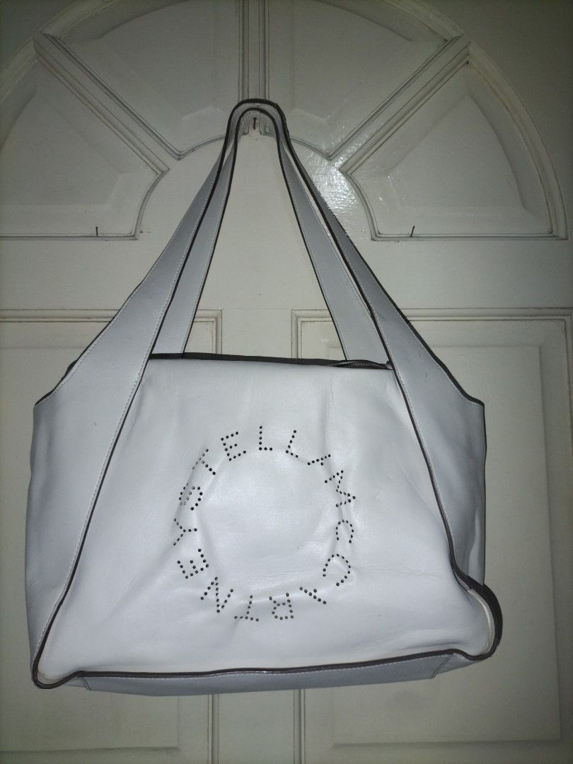 Stella McCartney Vegetarian Leather Shoulder Bag Neutral (Category: Luxury Bags & Wallets) located in Manila. Submitted by patriciab12636 (Listing ID 1465553741, Image 2). Description: White Stella McCartney shoulder bag made from vegetarian leather. Perforated circular logo on the front. Double shoulder straps closure. Spacious interior for daily essentials. Clean look with contrast dark piping..