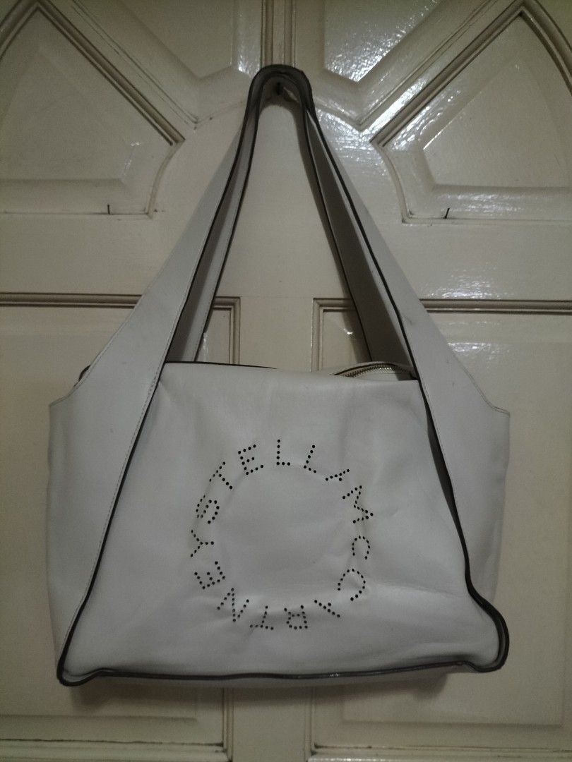 Stella McCartney Vegetarian Leather Shoulder Bag Neutral (Category: Luxury Bags & Wallets) located in Manila. Submitted by patriciab12636 (Listing ID 1465553741, Image 3). Description: White Stella McCartney shoulder bag made from vegetarian leather. Perforated circular logo on the front. Double shoulder straps closure. Spacious interior for daily essentials. Clean look with contrast dark piping..