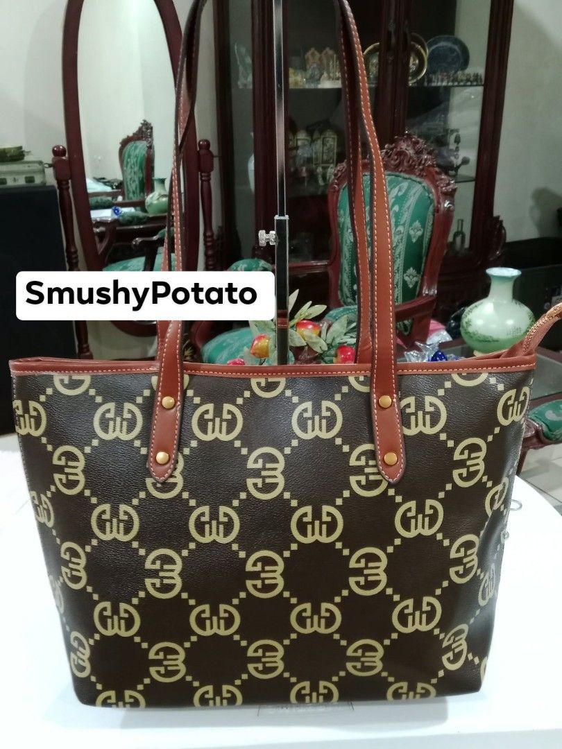 Structured brown tote bag distinguished by an all-over interlocking monogram pattern and tall leather-look shoulder straps. (Category: Tote Bags) located in Antipolo. Submitted by smushypotatoo (Listing ID 1465421950, Image 1). Description: .