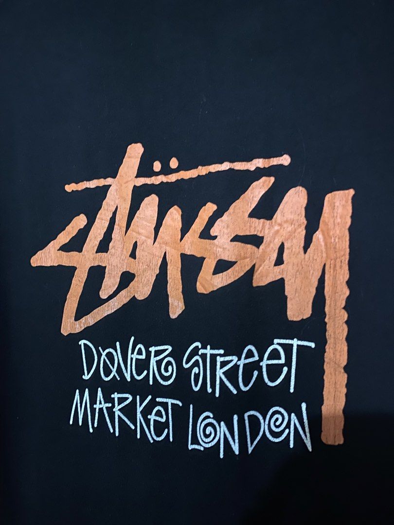 Stussy dover (Category: Tshirts & Polo Shirts ) located in Jaen. Submitted by oshimamark58418 (Listing ID 1465475969, Image 3). Description: - Brand: Stussy - Collaboration: Dover Street Market London - Color: Black with orange and white graphic prints - Size: Medium (Made in Mexico) Dimes 20x29 - Design: Small front chest logo, large striking graphic on the back - Condition: Layered condition 7/10, soft and ready to wear - Style: Classic streetw