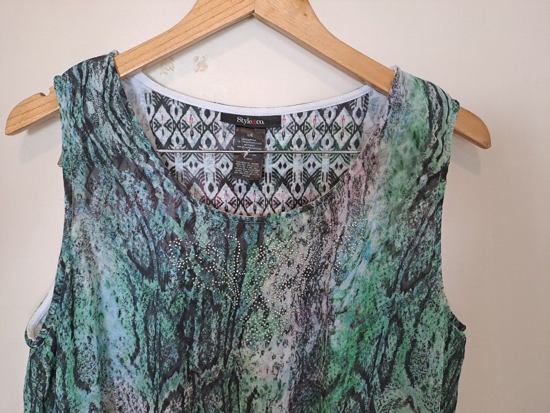 Style & Company sleeveless (Category: Sleeveless) located in Manila. Submitted by joanbalde39643 (Listing ID 1465438412, Image 2). Description: This is a style n compay women's sleeveless asymmetrical top featuring a layered design with a prominent green and blue snakeskin animal print on the sheer outer layer..