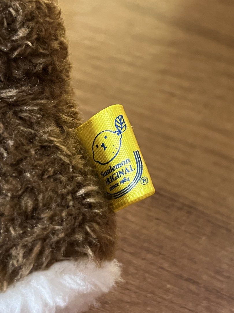 Sun Lemon Fluffy Tatton Sea Otter Plush (Category: Plushies & Soft Toys) located in Gapan. Submitted by lunashop14 (Listing ID 1465562591, Image 3). Description: - Brand: Sunlemon Original (Designed in Tokyo) - Condition: Brand new / Excellent - Design: Fluffy brown and white fur with a detailed embroidered face and tiny pink tongue - Special Feature: Holding a small round yellow ball - Authenticity: Comes with the official yellow fabric tag on t