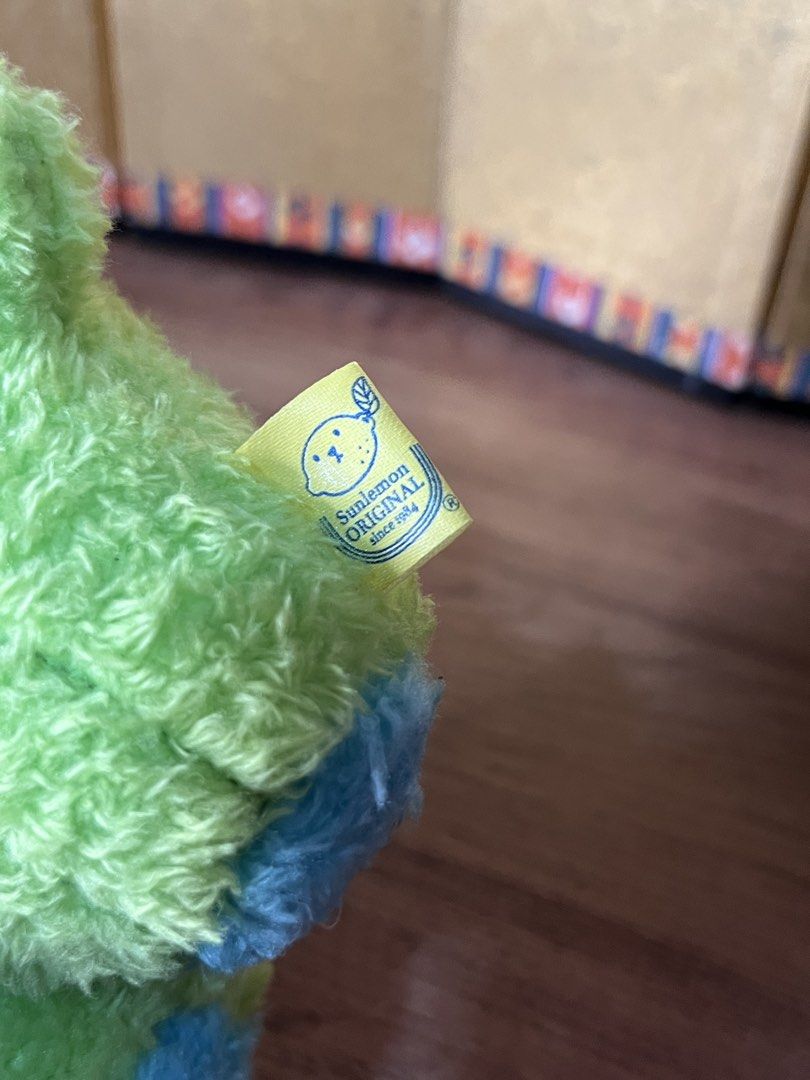 Sunlemon Fluffy Tatton Cactus Plush (Category: Plushies & Soft Toys) located in Gapan. Submitted by lunashop14 (Listing ID 1465562654, Image 3). Description: - Authentic Sunlemon Original green cactus plush - Features cute closed eyes and brown nose embroidery - Adorable tiny blue hands and feet with purple spikes - Soft, fuzzy, and clean fabric throughout - Original yellow tag attached with brand logo and text.