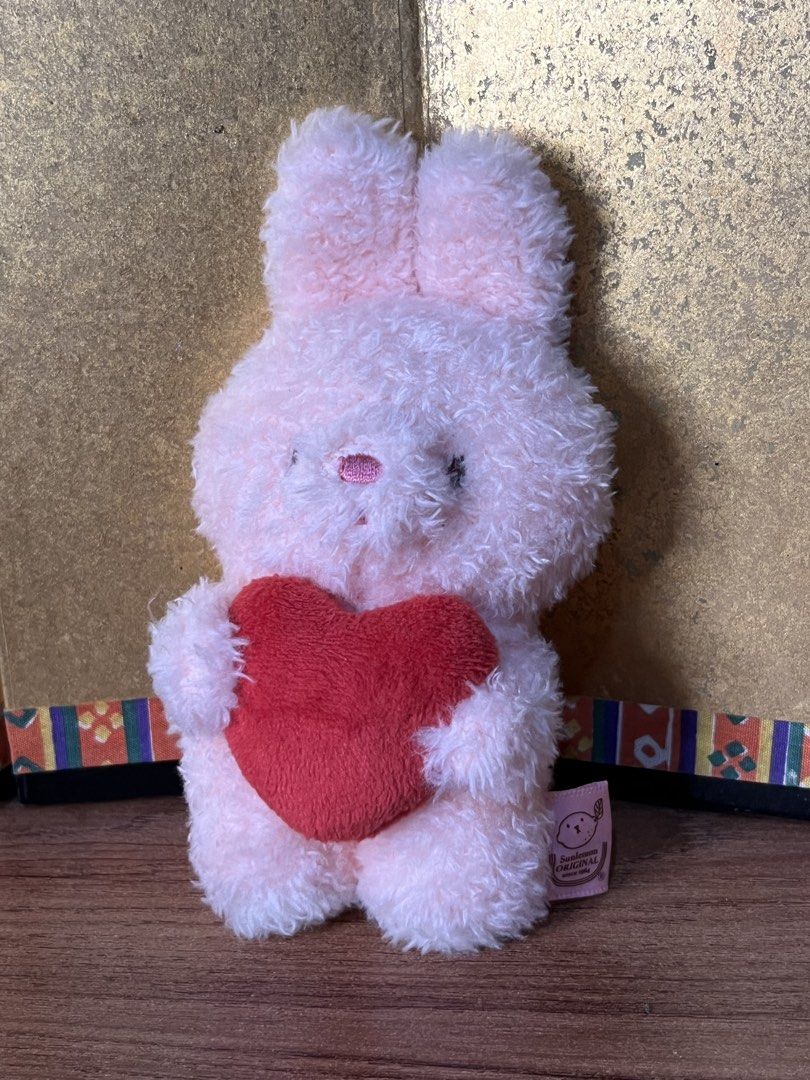 Sunlemon Fluffy Tatton Heart Rabbit SS Plush (Category: Plushies & Soft Toys) located in Gapan. Submitted by lunashop14 (Listing ID 1465562755, Image 2). Description: - Brand: Sunlemon Original (Designed in Tokyo) - Design: Pink fluffy rabbit holding a soft red heart - Texture: Fluffy textured fur all over - Condition: Excellent, clean tags, no stains or damage.