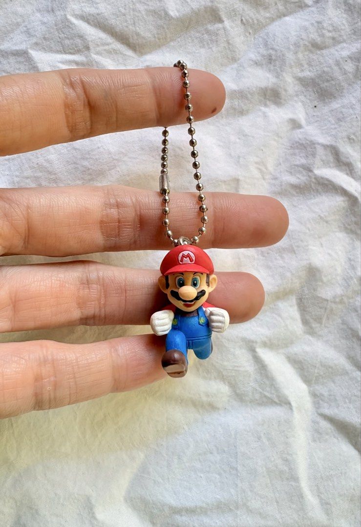 Super Mario Running Figurine Keychain Nintendo (Category: Character Goods) located in Tuguegarao City. Submitted by jasminecoll (Listing ID 1465538026, Image 1). Description: - Classic Super Mario running figurine keychain - Iconic design featuring red cap, blue overalls, and white gloves - Equipped with a sturdy metal ball chain for bags or keys -mini location Tuguegarao City North Luzon Sf start @65.