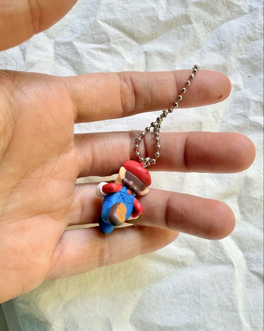 Super Mario Running Figurine Keychain Nintendo (Category: Character Goods) located in Tuguegarao City. Submitted by jasminecoll (Listing ID 1465538026, Image 2). Description: - Classic Super Mario running figurine keychain - Iconic design featuring red cap, blue overalls, and white gloves - Equipped with a sturdy metal ball chain for bags or keys -mini location Tuguegarao City North Luzon Sf start @65.