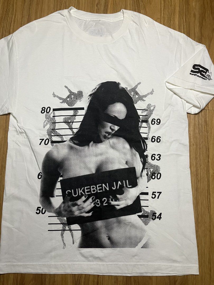 Super Sukeben Jail L •21.5x31 (Category: Tshirts & Polo Shirts ) located in Cebu City. Submitted by guttathreads (Listing ID 1465429794, Image 2). Description: - Brand: Super Sukeben - Color: Clean White - Size: Large (printed tag inside collar) - Material: 100% Cotton, Made in U.S.A. - Design: Large 'Sukeben Jail 324' mugshot graphic on the front - Detail: Small logo print on the left sleeve - Condition: Great quality with solid, un-fADEd prints