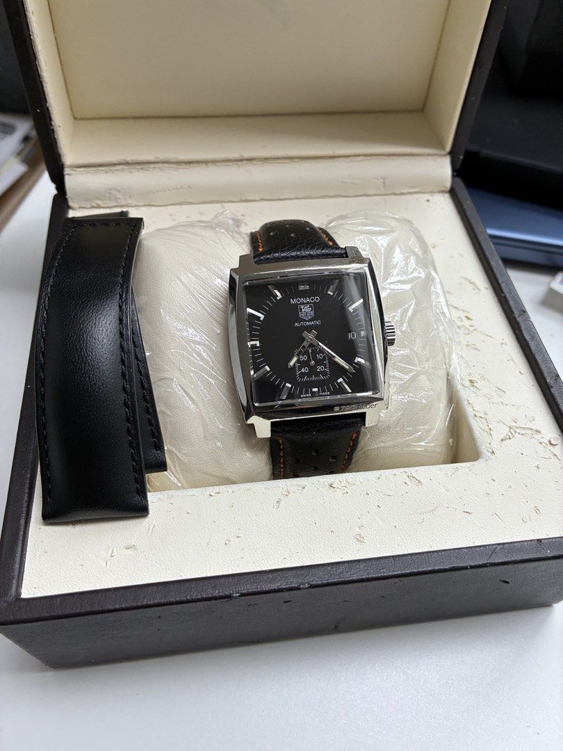TAG Heuer Monaco Automatic Watch with Leather Strap (Category: Luxury Watches) located in Las Pinas. Submitted by vastfish_f500fa (Listing ID 1465562854, Image 1). Description: - Model: TAG Heuer Monaco Automatic Watch - Dial: Black square dial with bottom sub-dial and date window at 3 o'clock - Case: Exhibition case back displaying the mechanical movement - Strap: Black leather rally strap with orange stitching, plus extra strap piece - Inclusio