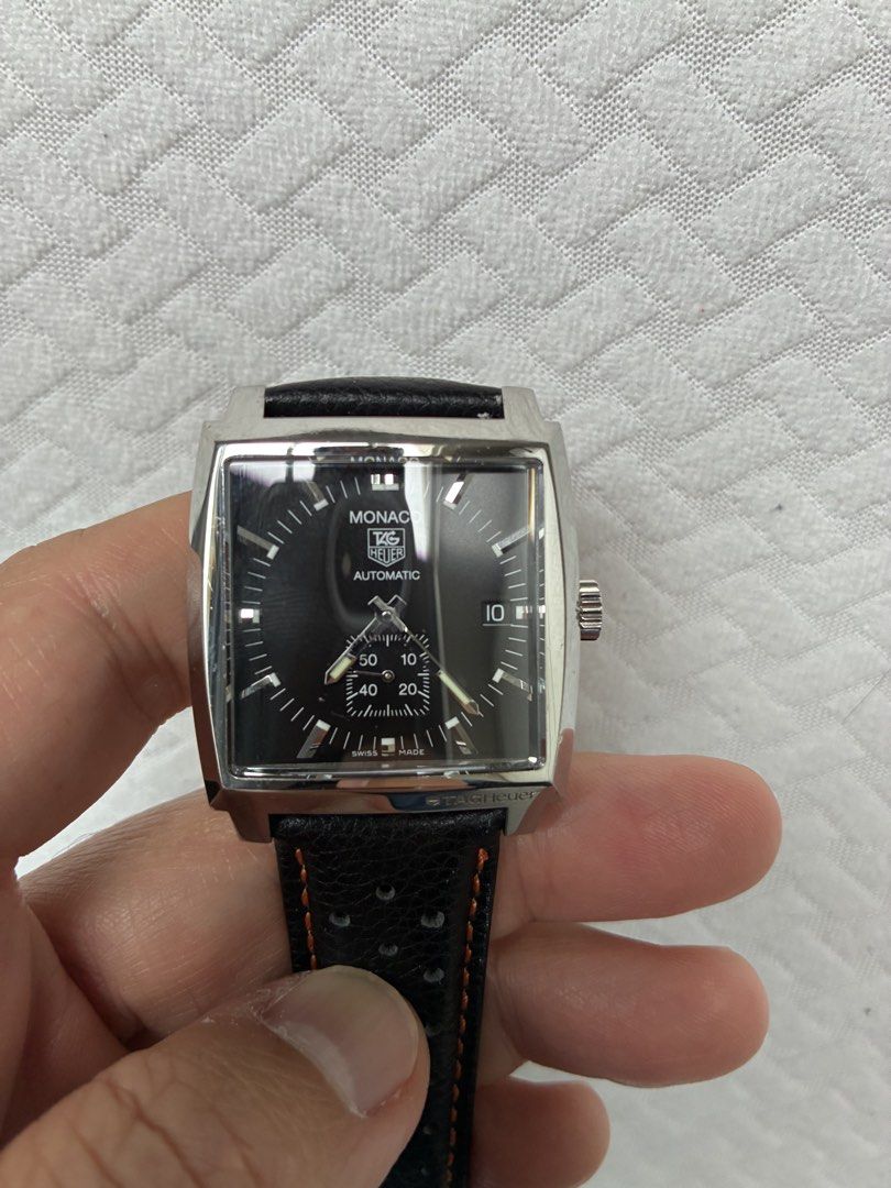 TAG Heuer Monaco Automatic Watch with Leather Strap (Category: Luxury Watches) located in Las Pinas. Submitted by vastfish_f500fa (Listing ID 1465562854, Image 2). Description: - Model: TAG Heuer Monaco Automatic Watch - Dial: Black square dial with bottom sub-dial and date window at 3 o'clock - Case: Exhibition case back displaying the mechanical movement - Strap: Black leather rally strap with orange stitching, plus extra strap piece - Inclusio