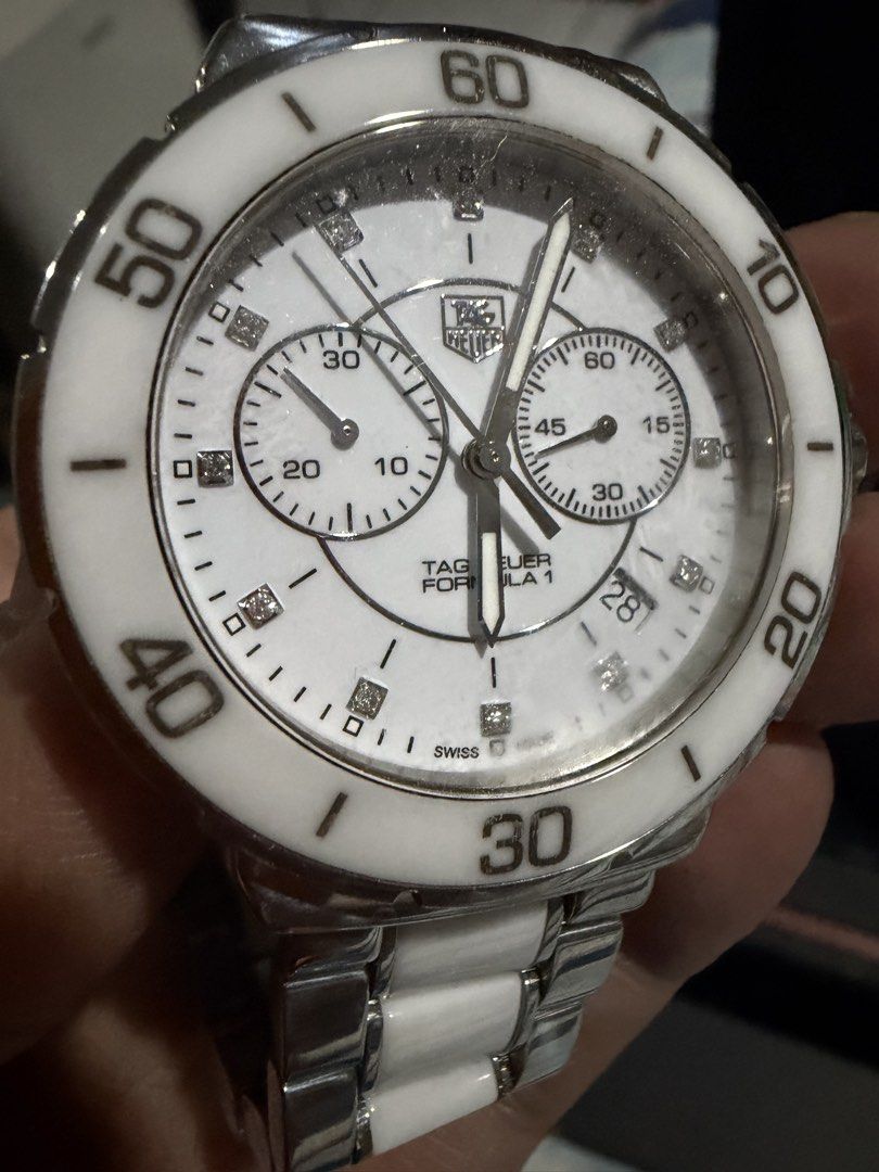Tag Huer Formula 1 Chrono (Category: Luxury Watches) located in Taguig. Submitted by Zyannah (Listing ID 1465466130, Image 3). Description: Preloved but well loved Tag Huer Formula 1 Chrono watch. White face with diamond and white ceramic strap. 41mm face.17.5cm wrist measurement. Can be a unisex watch. Plus shipping. Check status/condition of the boxes on the last photos. The main box has chipped off due to weather and storage. No rush shipping 
