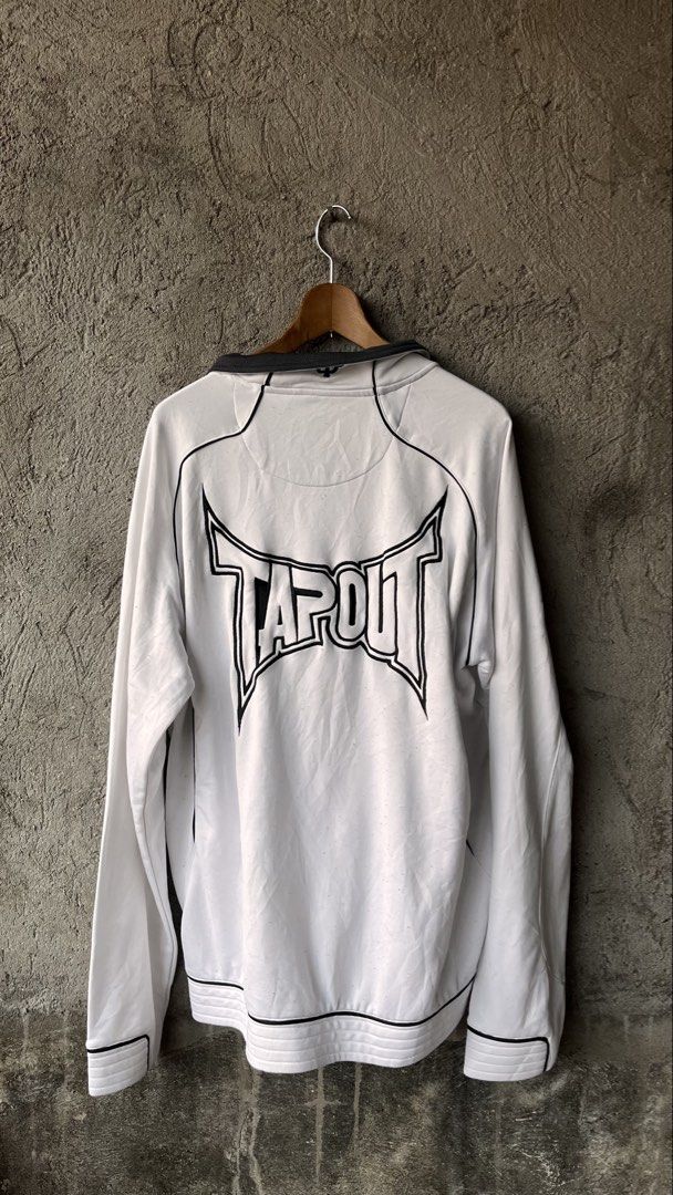 Tapout White Full Zip Track Jacket 2XL (Category: Coats, Jackets and Outerwear) located in Cabuyao City. Submitted by bulandos (Listing ID 1465475730, Image 2). Description: - Brand: Tapout - Size: 2XL - Color: White with black contrast collar and piping - Design: Big logo on the back and small logo on the chest - Features: Full zip front, two zipped pockets with bullet-style metal pulls - Material: 100% polyester.