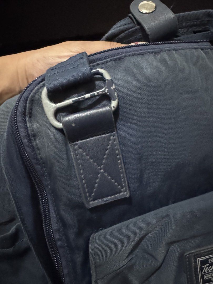 Technopack Navy Blue Backpack with Front Pocket (Category: Backpacks) located in Pasig City. Submitted by oinkrowie (Listing ID 1465497012, Image 2). Description: - Color: Dark Navy Blue - Features: Front pouch pocket with buckled straps, woven brand patch, dual top carry handles, and adjustable shoulder straps - Storage: Wide-opening zippered main compartment with interior mesh pockets and organizers - Condition: Minor fabric wear from normal us