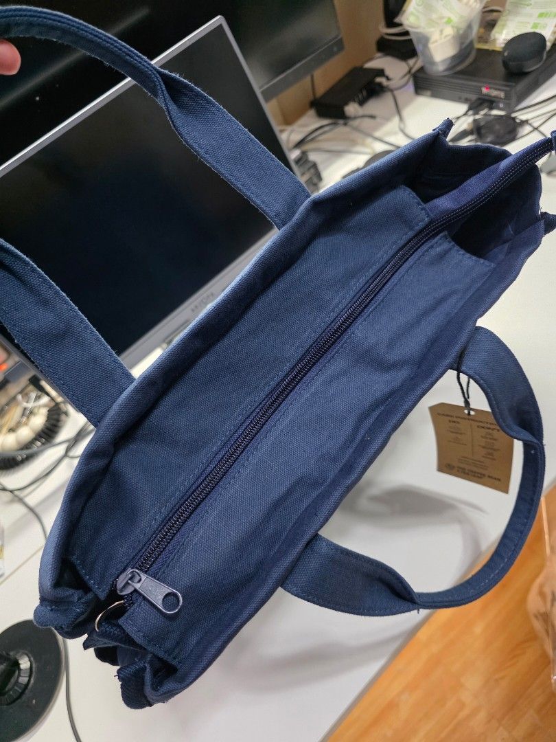 The Coffee Bean & Tea Leaf Navy Blue Canvas Bag (Category: Tote Bags) located in Manila. Submitted by jms_shopping (Listing ID 1465452052, Image 3). Description: - Brand new with original paper tag attached - Authentic The Coffee Bean & Tea Leaf merchandise - Color: Solid dark blue canvas - Features secure zip-top closure and dual top handles - Includes a convenient detachable shoulder strap with metal clips - Handy exterior front pocket for quic