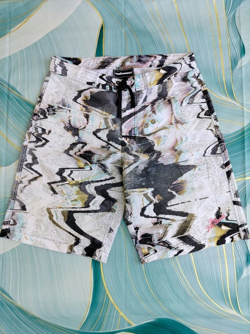 The Hundreds Abstract Print Board Shorts (Category: Swim Trunks & Board Shorts) located in Manila. Submitted by virgiliosa38485 (Listing ID 1465497327, Image 1). Description: - Brand: The Hundreds -Size 34 -Length 21 - Design: Cool black, white, and pastel abstract print with embroidered logo near the hem - Waistband: Secure drawstring design - Pockets: Back pocket with small branded tag and drainage grommets - Fabric: Lightweight and quick-dryin