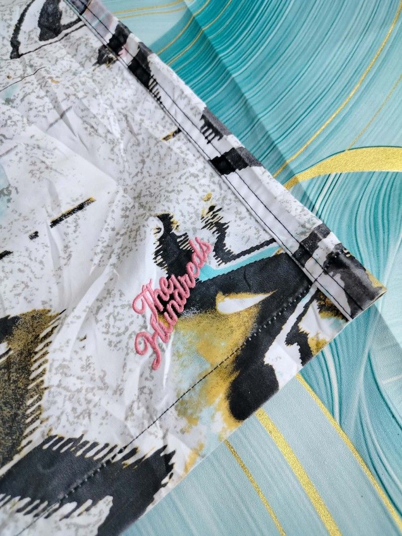 The Hundreds Abstract Print Board Shorts (Category: Swim Trunks & Board Shorts) located in Manila. Submitted by virgiliosa38485 (Listing ID 1465497327, Image 2). Description: - Brand: The Hundreds -Size 34 -Length 21 - Design: Cool black, white, and pastel abstract print with embroidered logo near the hem - Waistband: Secure drawstring design - Pockets: Back pocket with small branded tag and drainage grommets - Fabric: Lightweight and quick-dryin