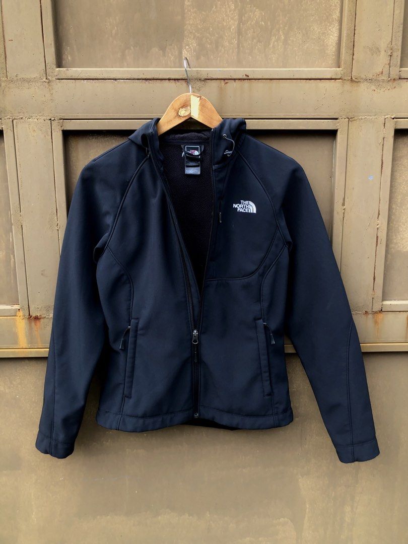 The North Face Black Softshell Hooded Jacket (Category: Coats, Jackets and Outerwear) located in Manila. Submitted by yocsthrifted (Listing ID 1465522685, Image 3). Description: North Face softshell jacket in black. Full zip front, adjustable hood, and zippered chest pocket. Side pockets included for everyday utility. Fleece lining inside for warmth. Clean aesthetic, standard fit, easy to match with daily outfits..