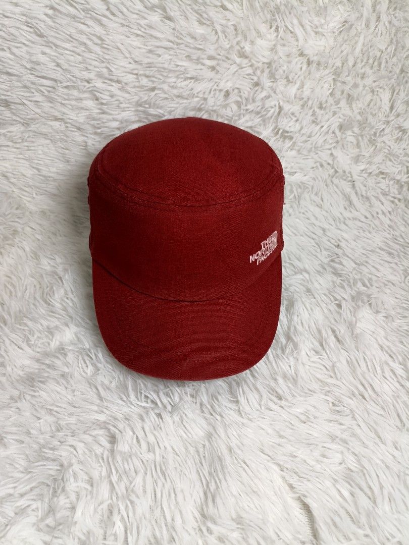 The North Face Cadet Cap Red (Category: Caps & Hats) located in Imus. Submitted by grindhouse.thriftshop (Listing ID 1465418236, Image 1). Description: - Brand: The North Face - Style: Red canvas cadet cap - Details: Embroidered white logo on front, decorative patterned band around the base - Fit: Adjustable hook-and-loop strap closure at the back - Interior: Sweatband with repeated logo text branding, inner tag attached - Condition: Excellent, r