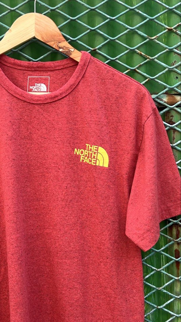 The North Face Red Graphic T-Shirt Medium (Category: Tshirts & Polo Shirts ) located in Manila. Submitted by roysntg2447882 (Listing ID 1465389933, Image 3). Description: - Brand: The North Face - Color: Red Heathered - Size: Medium (Regular Fit) - Material: 98% Recycled Materials - Design: Small yellow logo on chest, large graphic triangle on the back - Fit/Style: Crew neck, short sleeves, comfortable everyday tee.
