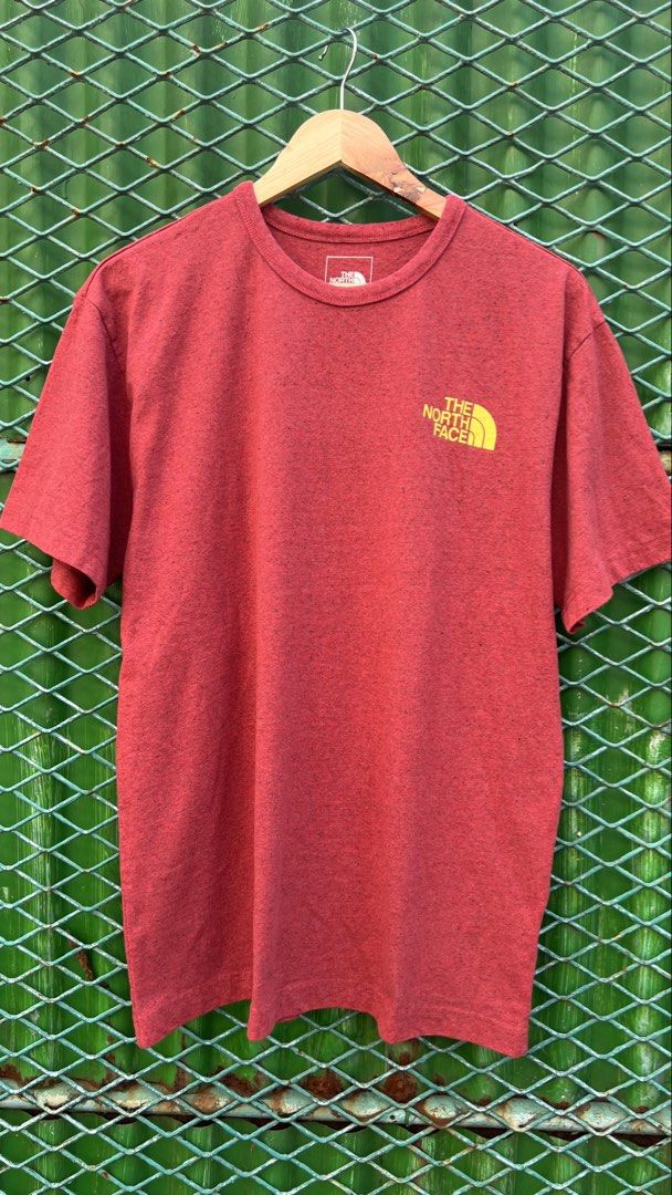 The North Face Red Graphic T-Shirt Medium (Category: Tshirts & Polo Shirts ) located in Manila. Submitted by roysntg2447882 (Listing ID 1465389933, Image 1). Description: - Brand: The North Face - Color: Red Heathered - Size: Medium (Regular Fit) - Material: 98% Recycled Materials - Design: Small yellow logo on chest, large graphic triangle on the back - Fit/Style: Crew neck, short sleeves, comfortable everyday tee.
