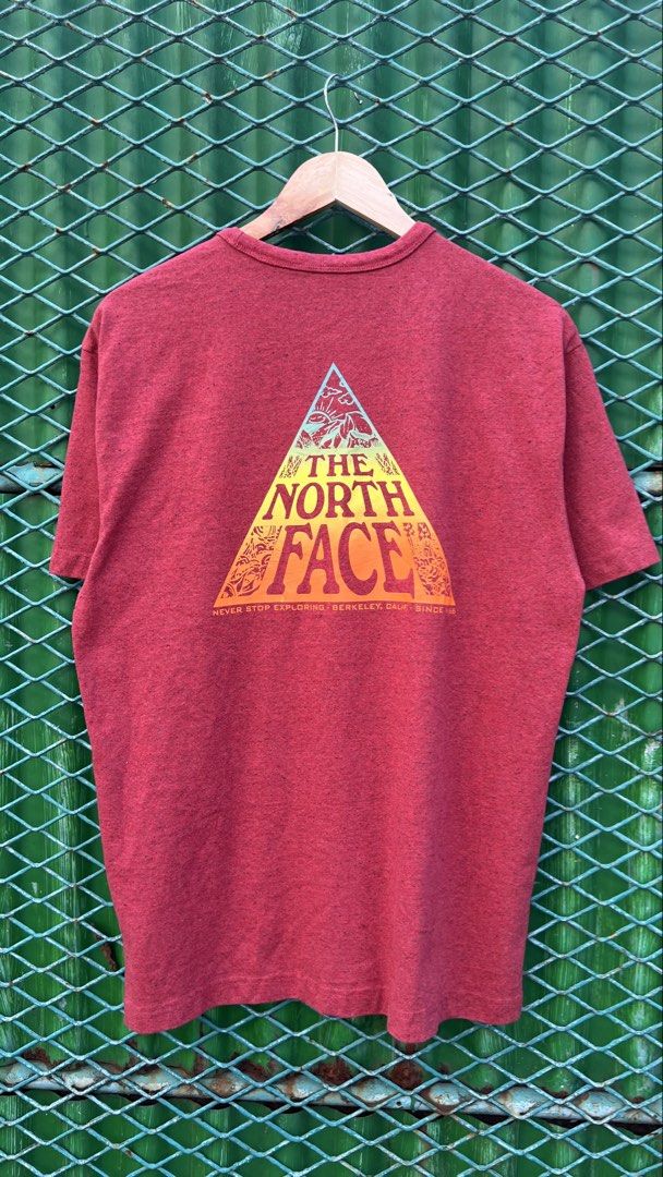 The North Face Red Graphic T-Shirt Medium (Category: Tshirts & Polo Shirts ) located in Manila. Submitted by roysntg2447882 (Listing ID 1465389933, Image 2). Description: - Brand: The North Face - Color: Red Heathered - Size: Medium (Regular Fit) - Material: 98% Recycled Materials - Design: Small yellow logo on chest, large graphic triangle on the back - Fit/Style: Crew neck, short sleeves, comfortable everyday tee.