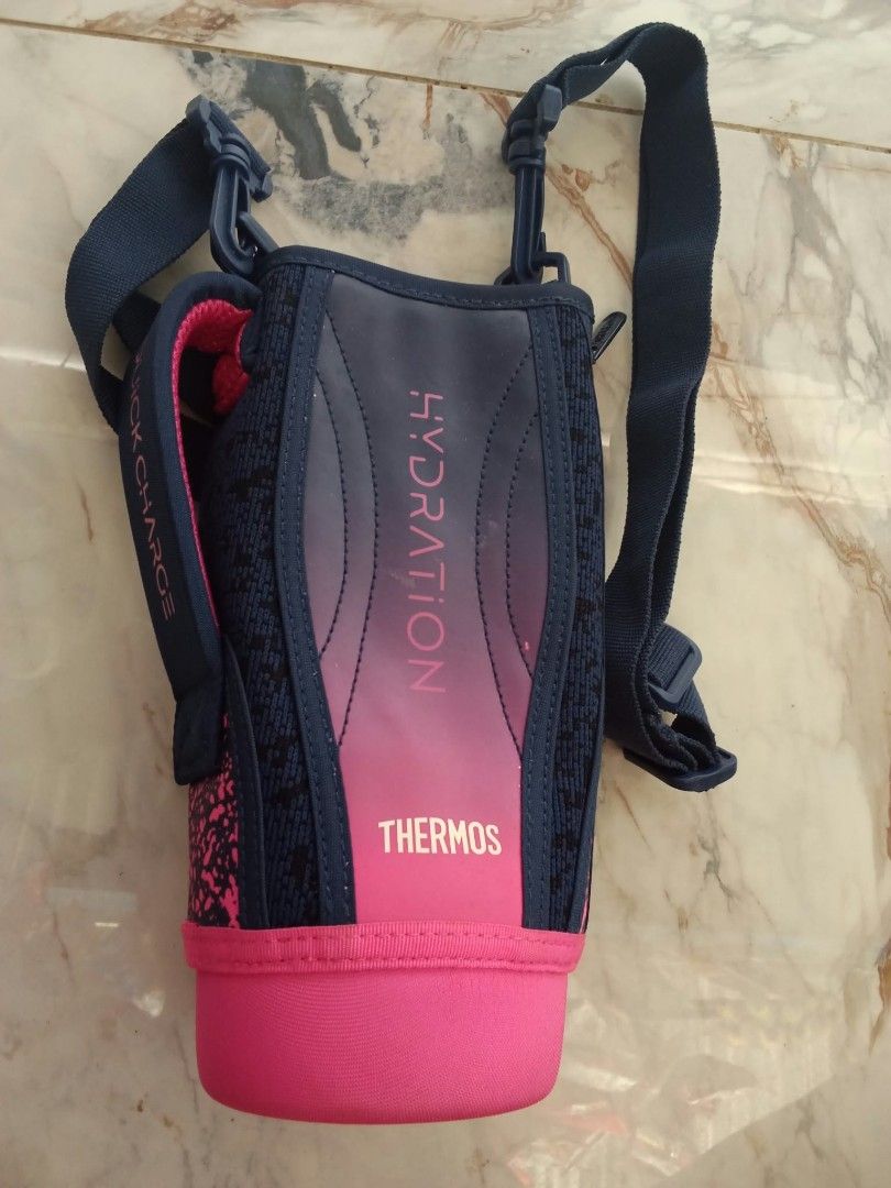Thermos Hydration Bottle Pouch with Strap (Category: Water Bottles & Tumblers) located in Davao. Submitted by mengsmixitems (Listing ID 1465424214, Image 2). Description: - Brand: Thermos - Color: Dark blue and pink - Features: Adjustable shoulder strap, padded handle, and secure side zipper closure - Condition: Clean interior with original Japanese tag attached - Perfect for daily hydration on the go fit -fit to 22oz.