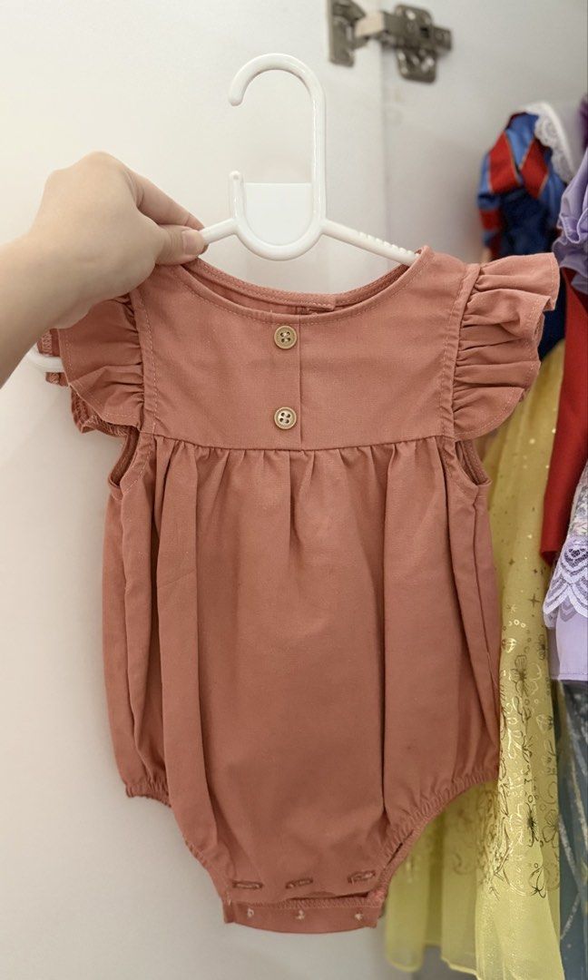 Tiny Threads by Laila &Lyra Romper and Bear Dress Set (Category: Babies & Kids Fashion) located in Manila. Submitted by westcoastk76738 (Listing ID 1465441358, Image 2). Description: - Set of 2 adorable pieces for baby girls - Pink ruffled shoulder romper (Size: 0-6 months) with back buttons and bottom snap closures for easy diaper changes - Mustard yellow bear pinafore dress featuring cute front pockets and a sweet bear face graphic - Material: 