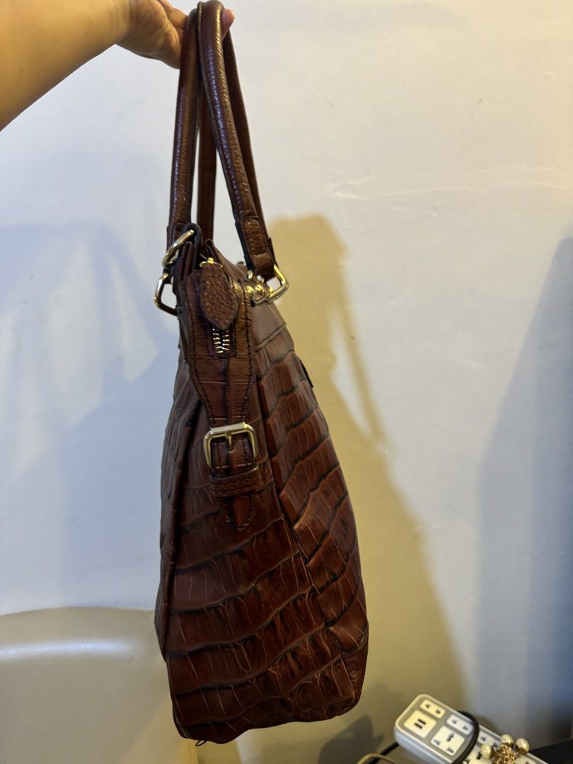 Tod's Brown Crocodile Embossed Leather Tote Bag (Category: Tote Bags) located in Urdaneta. Submitted by kathleenja24136 (Listing ID 1465472019, Image 2). Description: - Authentic Tod's leather handbag in a rich brown shade - Striking crocodile-embossed texture on the lower half - Comfortable dual shoulder straps and elegant gold-tone hardware - Signature debossed Tod's logo patch on the front - Secure zip closure with adjustable buckle strap side