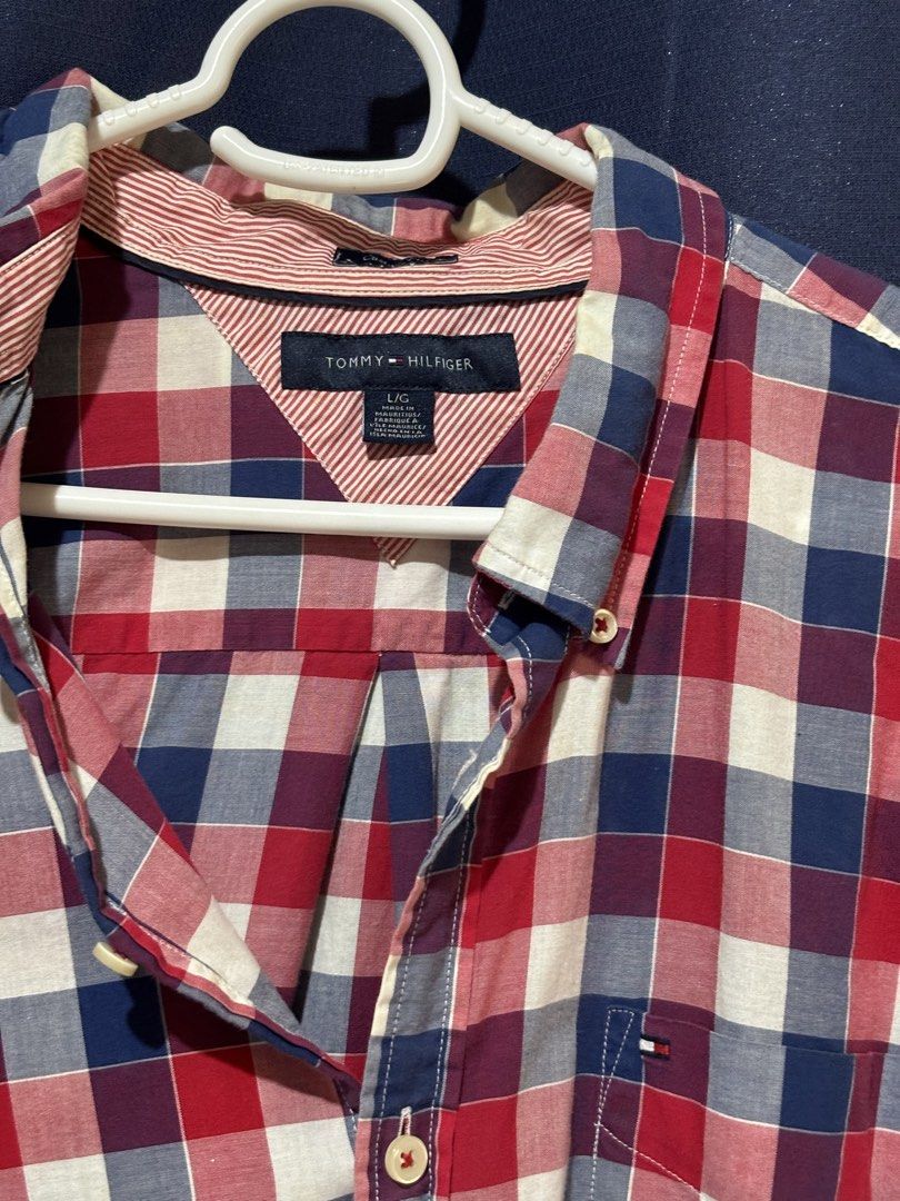 Tommy Hilfiger Plaid Button-Down Shirt Size L (Category: Tshirts & Polo Shirts ) located in Rosario. Submitted by aira_caeli (Listing ID 1465520073, Image 2). Description: - Brand: Tommy Hilfiger - Size: L (Normal fit) - Color: Classic red, navy blue, and white plaid - Material: Lightweight cotton (Made in Mauritius) - Details: Button-up front, chest pocket, signature flag embroidery, and striped contrast fabric inside the collar band - Condition