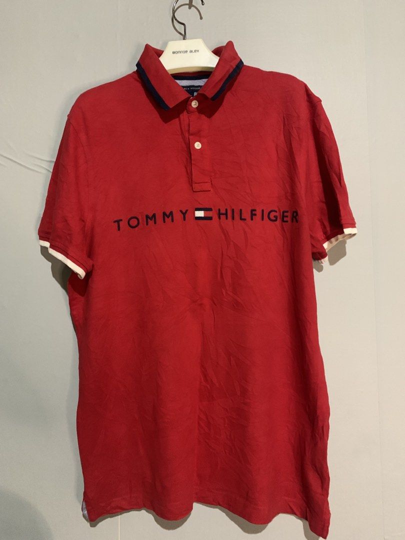 Tommy Hilfiger Red Polo Shirt Medium (Category: Tshirts & Polo Shirts ) located in San Miguel. Submitted by lights_thrifty00 (Listing ID 1465532027, Image 1). Description: - Brand: Tommy Hilfiger - Color: Red with navy blue and white accents - Size: Medium (Classic fit) - Material: 100% Cotton Knit - Details: Big embroidered chest lettering, contrast collar lining, sleeve tipping, branded two-button placket - Origin: Made in Vietnam - Condition: 