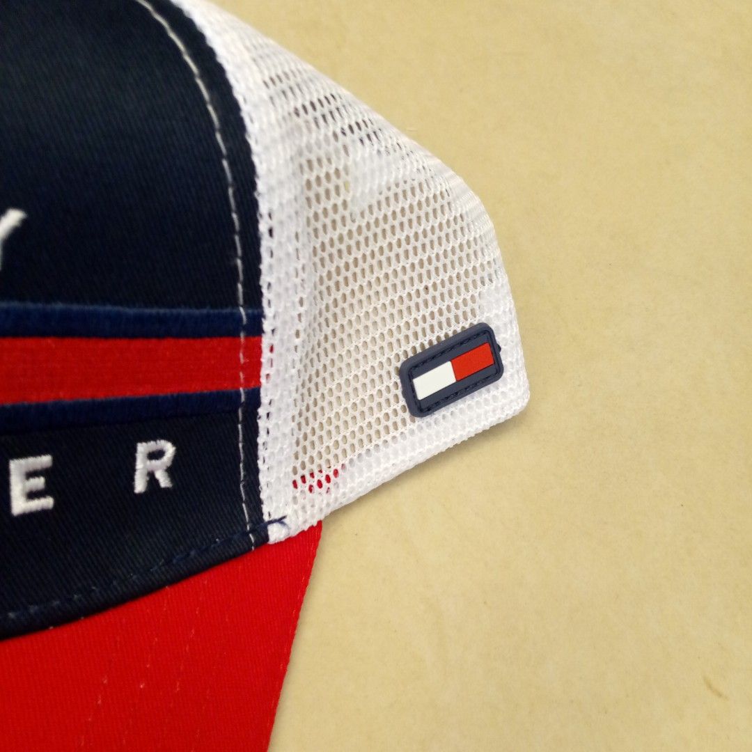 Tommy Hilfiger Trucker Hat Red White Blue (Category: Caps & Hats) located in Manila. Submitted by pablopresk0. (Listing ID 1465503649, Image 2). Description: - Brand: Tommy Hilfiger - Design: Classic colorblock in red, navy blue, and white with embroidered front branding - Comfort: Breathable mesh backing ideal for sunny days - Fit: Adjustable snapback closure for a custom fit - Details: Includes interior branded taping and original care tags Man