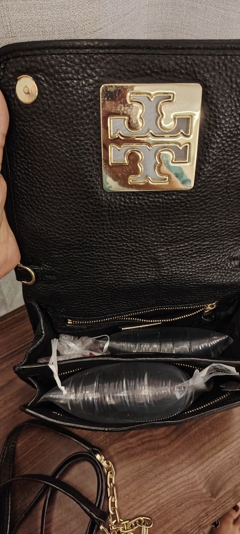 Tory Burch Black Leather Crossbody Bag (Category: Cross-body Bags) located in Caloocan City. Submitted by curatedbylez (Listing ID 1465478962, Image 2). Description: - Brand: Tory Burch - Material: Premium black pebble leather - Hardware: Gold-tone with prominent logo on the flap - Closure: Flap with magnetic snap - Strap: Adjustable leather shoulder strap with decorative chain detail - Interior: Multiple compartments and a zippered pocket with T