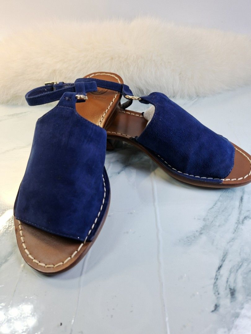 Tory Burch Blue Suede Sandals Size 5M (Category: Flats & Sandals) located in Pasay City. Submitted by onick_79 (Listing ID 1465529639, Image 2). Description: - Brand: Tory Burch - Material: Blue suede upper with brown leather soles and white contrast stitching - Heel: Comfortable low block heel - Closure: Ankle strap with adjustable gold-tone buckle hardware - Branding: Stamped Tory Burch logo on the insole - Condition: Light wear on the bottom s