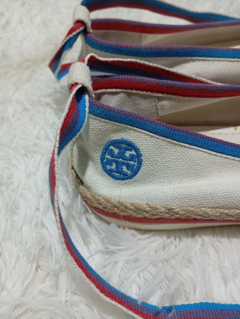 Tory Burch Canvas Ribbon Espadrille Flats (Category: Sneakers & Footwear) located in Quezon City. Submitted by thesecondmarketph (Listing ID 1465441405, Image 2). Description: - Brand: Tory Burch - Style: Canvas flats with blue and red ribbon ankle ties - Details: Jute rope trim sole and blue embroidered logo on the side heel - Perfect for: Summer outfits, casual days, and vacations.