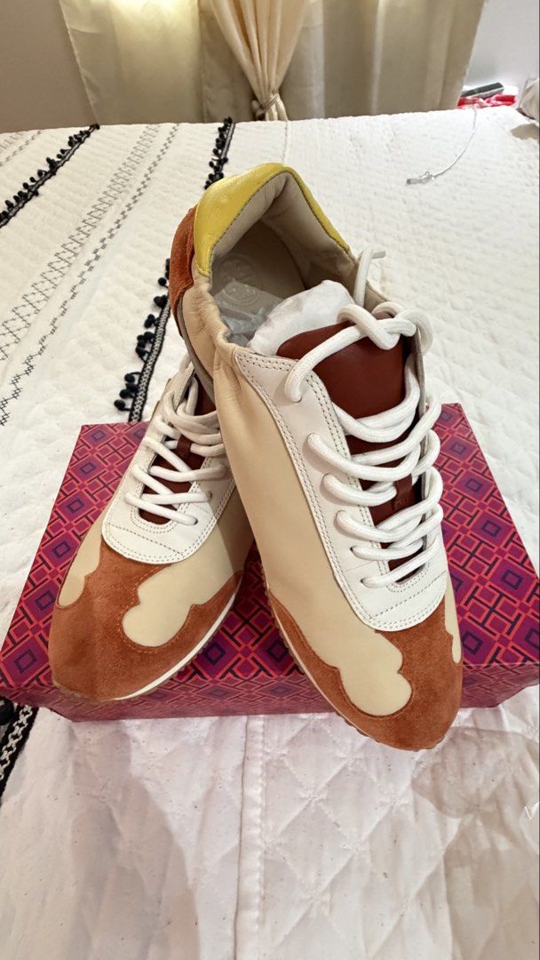 Tory Burch Tory Sneaker - Nylon / Calf Leather (Category: Sneakers) located in Mandaluyong City. Submitted by lizbeth031274 (Listing ID 1465428922, Image 1). Description: - Brand: Tory Burch - Model: Tory Sneaker - Color: New Ivory and Rust - Size: US 9 - Material: Nylon and calf leather upper with suede details, rubber sole - Inclusions: Original box and tissue paper included - Condition: Brand new with box.