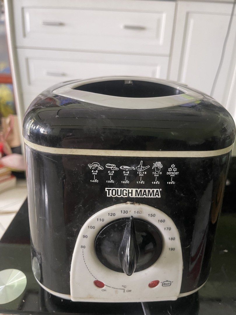 Tough Mama Deep Fryer (Category: Fryers) located in Manila. Submitted by pasaybestfinds (Listing ID 1465411988, Image 1). Description: - Brand: Tough Mama - Color: Black and White - Temperature Control: Adjustable dial from 80°C to 190°C - Built-in Guides: Handy cooking guides for mushrooms, bread, fish, chicken, and fries - Indicators: Includes convenient on and boil indicator lights - Condition: Used with some dust and marks on the outer casing