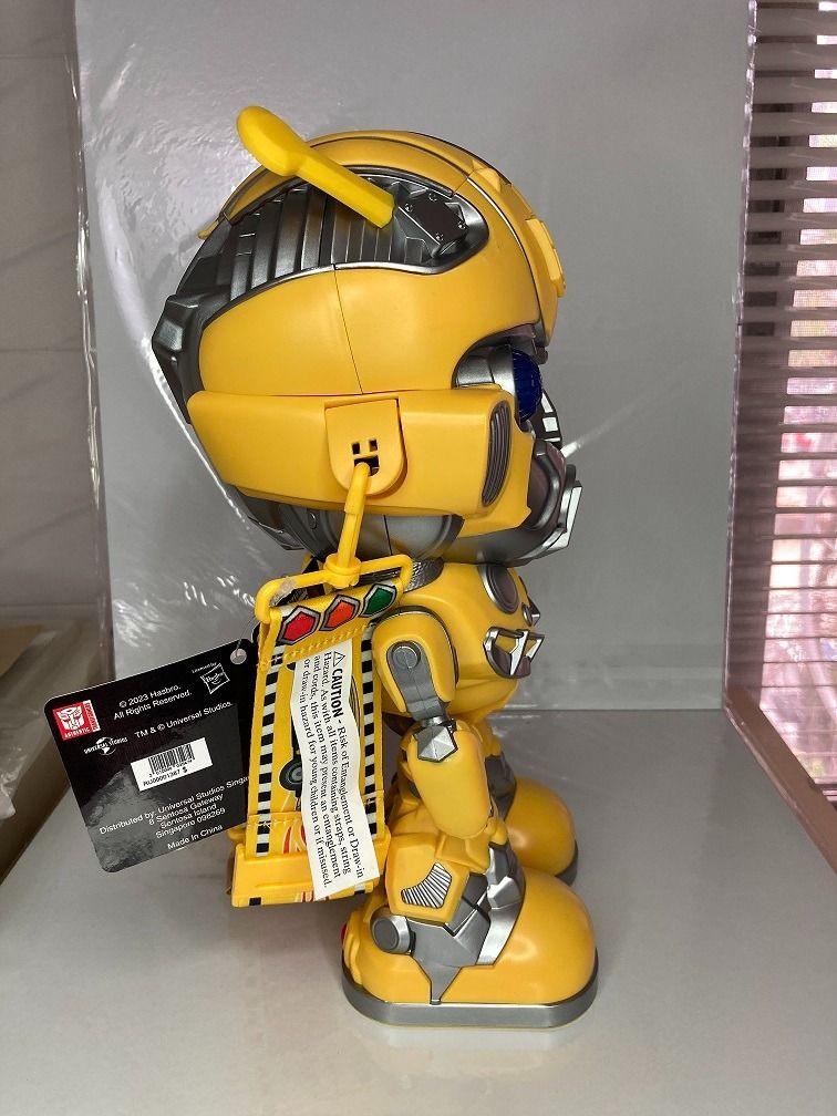 Transformers Bumblebee Popcorn Bucket with Strap (Category: Character Goods) located in Makati City. Submitted by gogokin (Listing ID 1465438204, Image 3). Description: - Official Transformers Bumblebee character popcorn bucket - Made of bright yellow and silver molded plastic - Features working glowing blue light-up eyes - Includes yellow carrying strap with movie imagery and film strip motifs - Brand new with original tag attached - Perfect fun