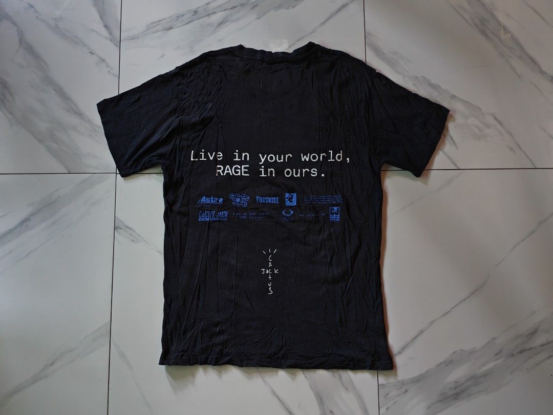 Travis Scott Cactus Jack PlayStation T-Shirt (Category: Tshirts & Polo Shirts ) located in Davao. Submitted by thrift2you (Listing ID 1465420913, Image 2). Description: - Item: Travis Scott Cactus Jack x PlayStation Tee - Color: Faded Black (washed look) - Size: Medium - Design: Large burning globe front graphic, PlayStation/Cactus Jack branding and 'Live in your world, RAGE in ours.' text on back - Material: 100% Cotton, Made in Mexico (© 2020 L