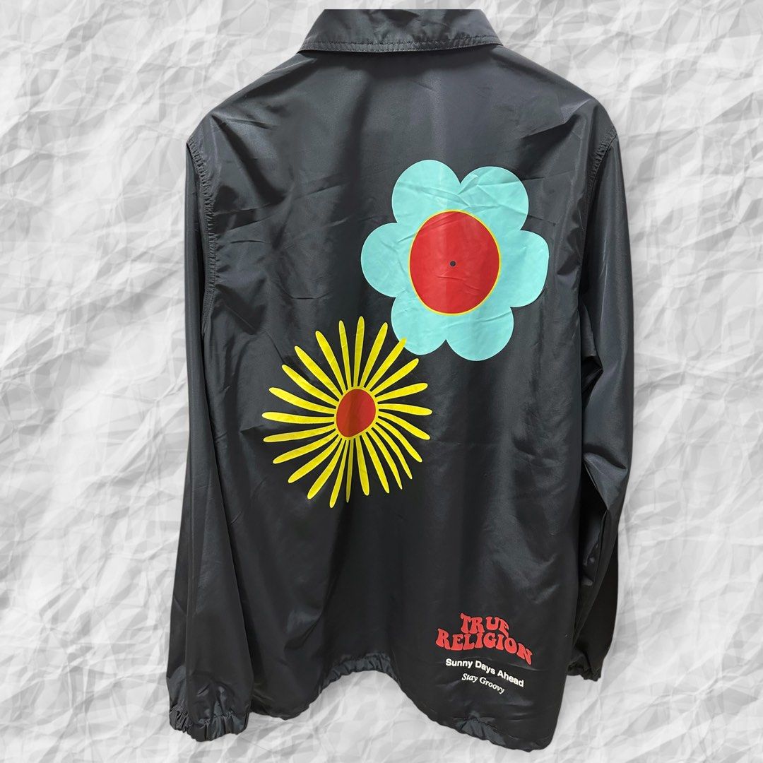 True Religion Basic Coach Jacket (Category: Coats, Jackets and Outerwear) located in Bulacan. Submitted by adoseofluxxee (Listing ID 1465480433, Image 2). Description: - Brand: True Religion - Item: Basic coach jacket - Color: Black - Size: Medium - Material: 100% polyester (shell and lining) - Front: Red True Religion logo text on the chest, button-up closure, side pockets, and collared neckline - Back: Large colourful floral prints with matchin