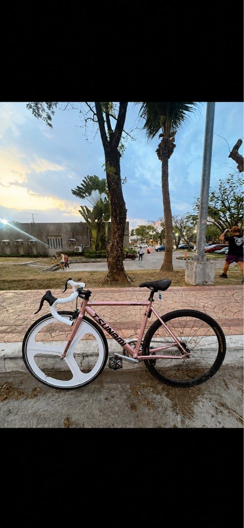 Tsunami SNM100 V3 S (Category: Bicycles) located in Pasay City. Submitted by niklauussss (Listing ID 1465473431, Image 1). Description: - Frame: Tsunami SNM100 fixed gear frame in Rose Gold - Wheelset: White tri-spoke front wheel & Mountainpeak deep-section rear wheel - Cockpit: Drop handlebars with fresh white tape and Eagle stem - Seating: Tanke saddle - Drivetrain: Skeace crankset with pedals and foot straps included - Condition: Ready to ride