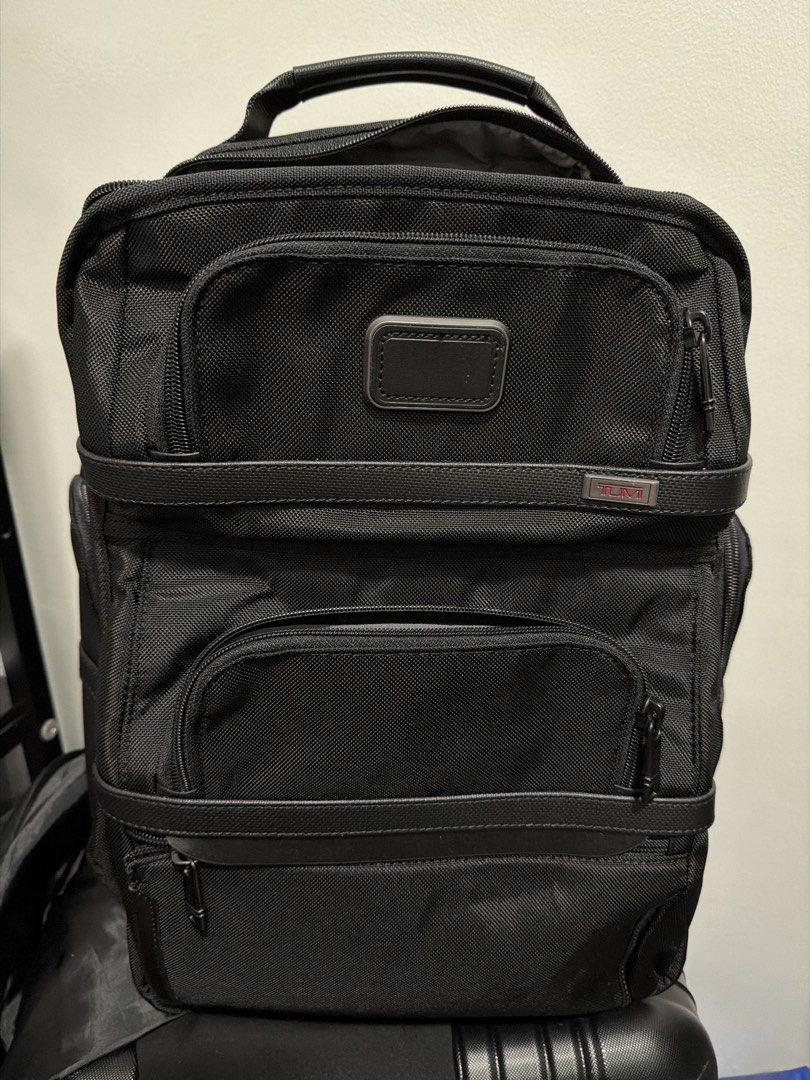 TUMI Alpha 3 backpack (Category: Backpacks) located in Pasig City. Submitted by xublime.cloud (Listing ID 1465485341, Image 1). Description: - Brand: TUMI - Color: Classic Black - Material: Rugged, durable ballistic nylon - Compartments: Multiple front zippered pockets for easy access - Interior: Grey fabric lining with built-in organizer slip pockets and card slots - Handle: Top carry handle featuring a stylish leather wrap detail - Accent: Sign