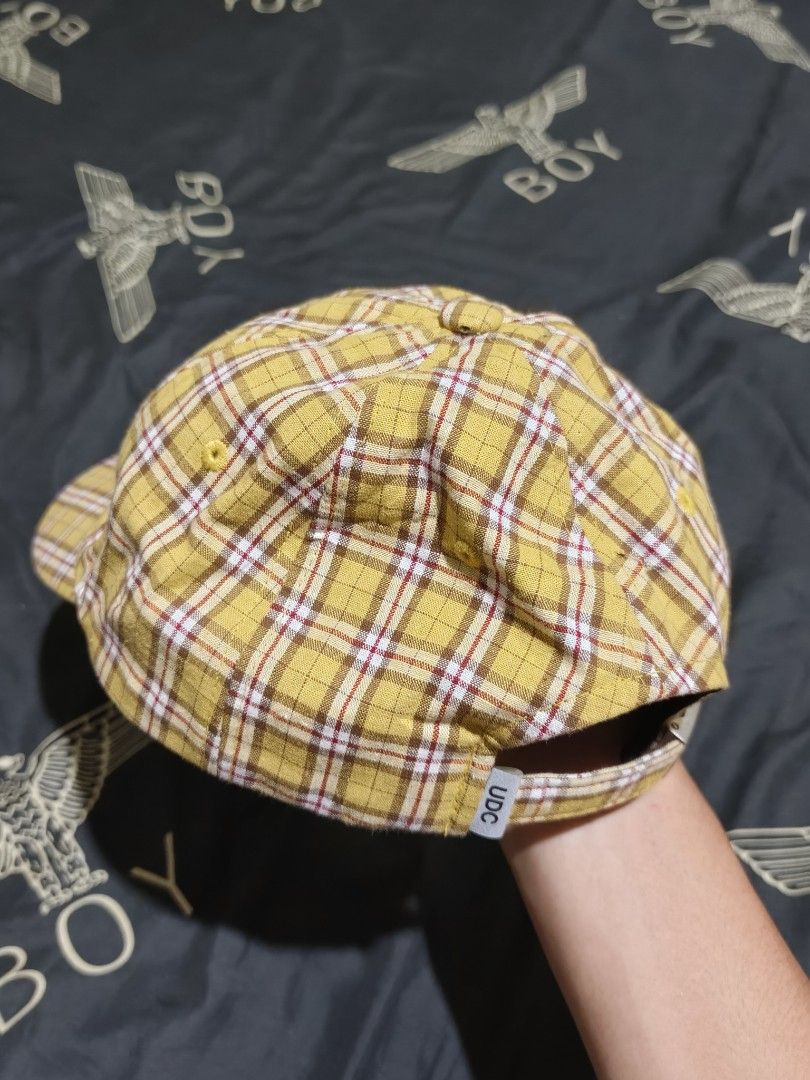 Undercontrol Yellow Plaid Cap UDC (Category: Caps & Hats) located in Cagayan de Oro. Submitted by epictiger_2a3d62 (Listing ID 1465412752, Image 3). Description: - Brand: Undercontrol - Design: Yellow plaid with white and maroon crisscross check pattern - Details: Embroidered brand text on the front panel and yellow ventilation eyelets - Closure: Adjustable strapback with a small UDC tag -Issue: with hole -Need wash.