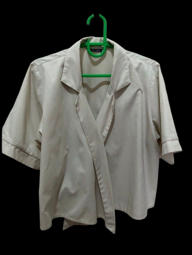 UNIFORM Beige Short Sleeve Wrap Blouse (Category: Blouses) located in Quezon City. Submitted by kcobs (Listing ID 1465427899, Image 1). Description: - Brand: UNIFORM - Color: Classic Beige - Style: Short sleeve blouse with lapel collar and wrap-style front - Fit: Relaxed fit, lightweight fabric - Details: Clean stitching along cuffs - Versatility: Perfect for casual outings or workwear.