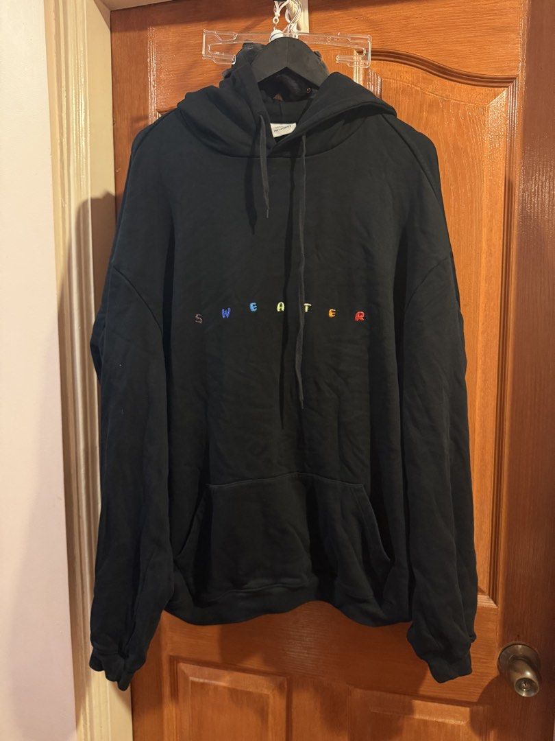 Vetemets hoodie hoodie (Category: Coats, Jackets and Outerwear) located in Quezon City. Submitted by djrakrakantodamax (Listing ID 1465485372, Image 1). Description: - Brand: Vetements (Hiver 2018 by Demna Gvasalia) - Color: Black with colorful embroidered "sweater" lettering across the chest - Size: Medium - Material: 80% cotton, 20% polyester (heavyweight fleece fabric) - Features: Kangaroo pocket, drawstring hood, long sleeves - Origin: Made i