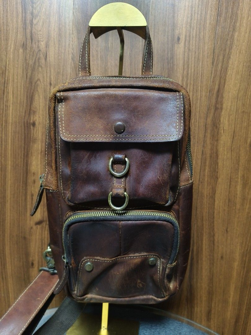 Vintage / Rustic Genuine Leather Sling Bag (Category: Sling Bags) located in Baguio. Submitted by PreiLoveMaria (Listing ID 1465490489, Image 3). Description: Vintage / Rustic Genuine Leather Sling Bag Add a rugged, vintage touch to your daily commute or casual days out with this genuine leather sling bag! Features a multi-pocket design, sturdy brass hardware, and an adjustable strap. in rustic condition with normal signs of vintage wear, scuffs,