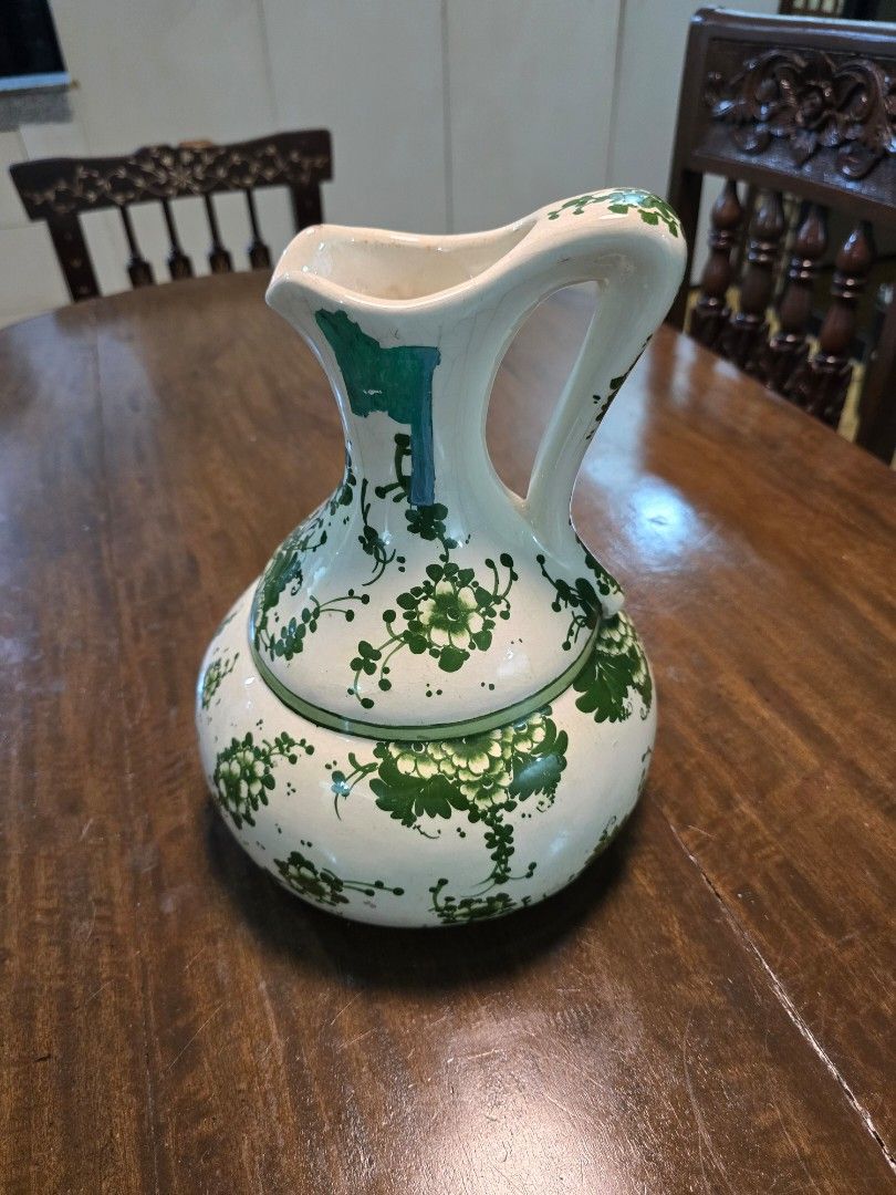 Vintage Hand-Painted Ceramic Pitcher / Decorative Ewer (Category: Pitchers & Dispensers) located in Pasig City. Submitted by lancevinola (Listing ID 1465503733, Image 1). Description: Beautiful vintage ceramic pitcher featuring a cream-white glazed body with intricate green floral and botanical decoration. The piece has a distinctive rounded shape, elegant curved handle, wide pouring lip, and decorative painted details throughout. Visible glaze c