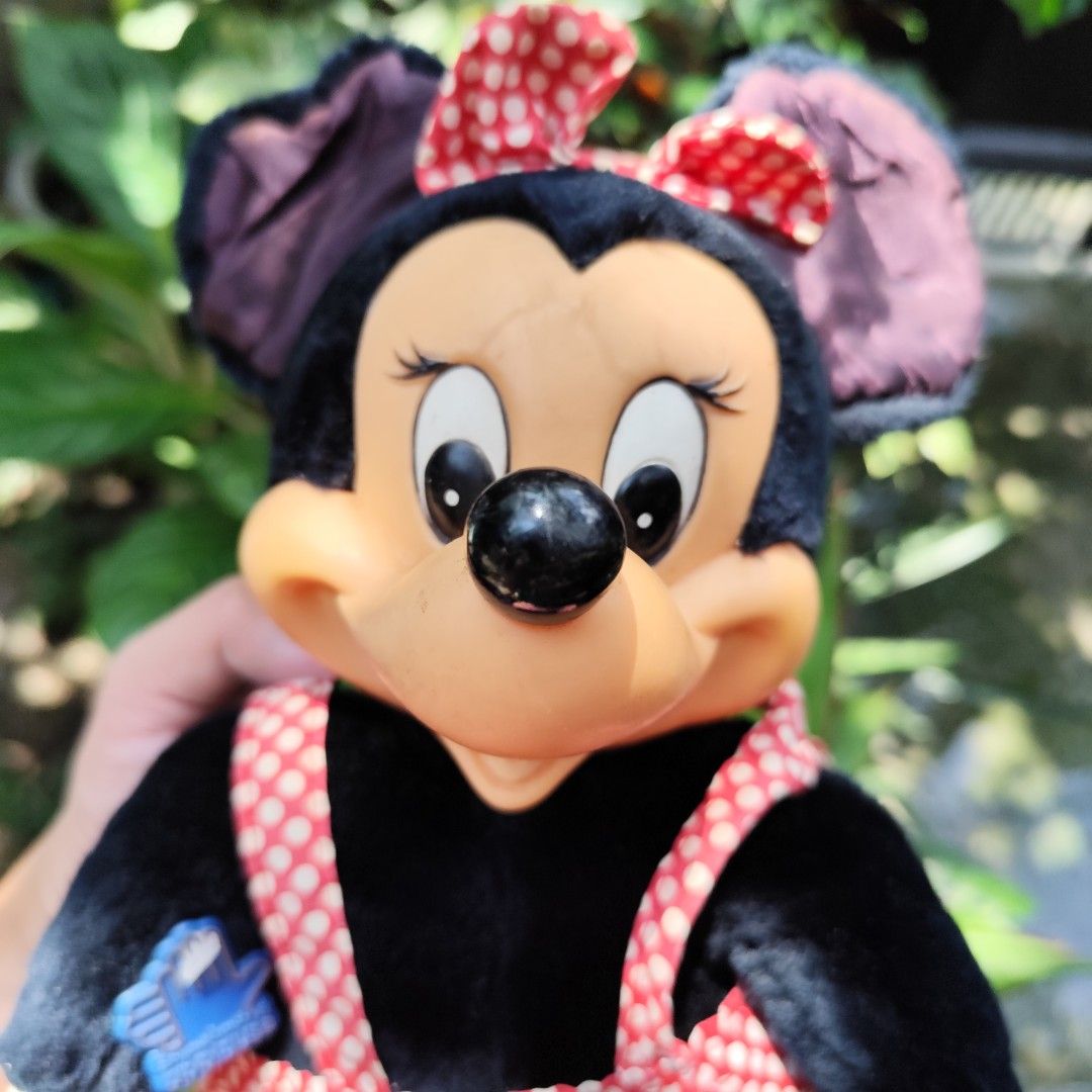Vintage Minnie Mouse Applause Plush Doll (Category: Plushies & Soft Toys) located in Rizal. Submitted by mamamamawskey_031284 (Listing ID 1465433757, Image 2). Description: Vintage Minnie Mouse plush doll by Applause. Black plush body with hard plastic face and shoes. Red and white polka dot skirt with matching hair bow. Blue Applause hand tag attached to chest. Original fabric tag tucked inside the skirt. Shows some age and wear on the fabric el