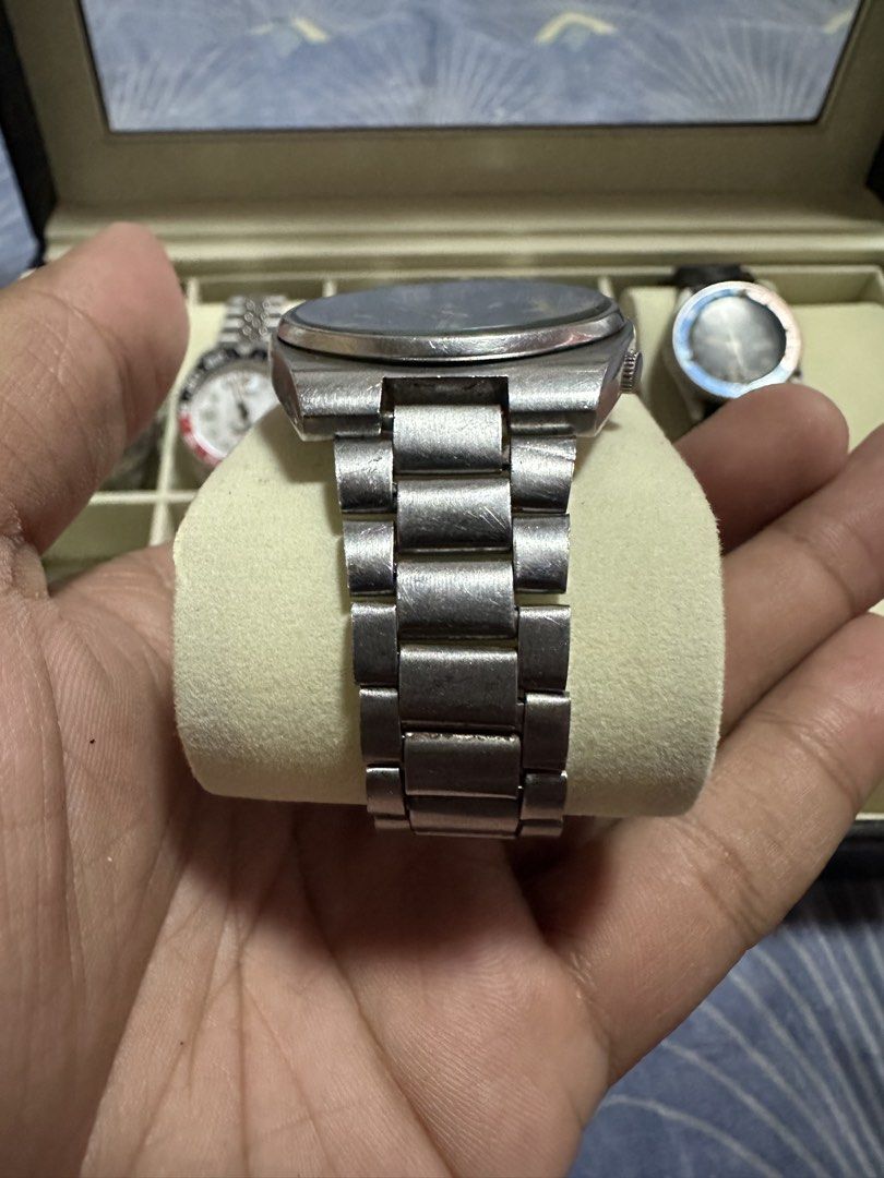 Vintage Seiko 5 Automatic Watch with Black Dial (Category: Men's Watches) located in Manila. Submitted by zealdeer_4239a8 (Listing ID 1465546272, Image 2). Description: - Brand/Model: Seiko 5 Automatic Watch - Dial: Dark black dial with day-date window at 3 o'clock - Material: Stainless steel case and matching steel link bracelet with engraved Seiko clasp - Movement: Automatic (keeps time well) - Condition: Visible scuffs and wear from daily use 