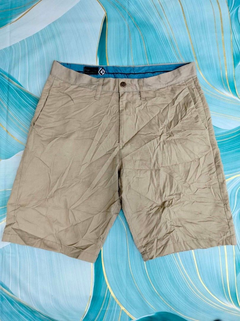 Volcom Corpo Class Men's Beige Shorts Size 33 (Category: Shorts) located in Manila. Submitted by virgiliosa38485 (Listing ID 1465502580, Image 1). Description: - Brand: Volcom - Color: Beige with teal inner waistband lining - Size: Tagged 33-34 -Length 21.5 - Closure: Button fly - Pockets: Front/back welt pockets and small side utility pocket - Details: Embroidered Volcom stone logo on lower leg and back pocket - Style: Casual wear.
