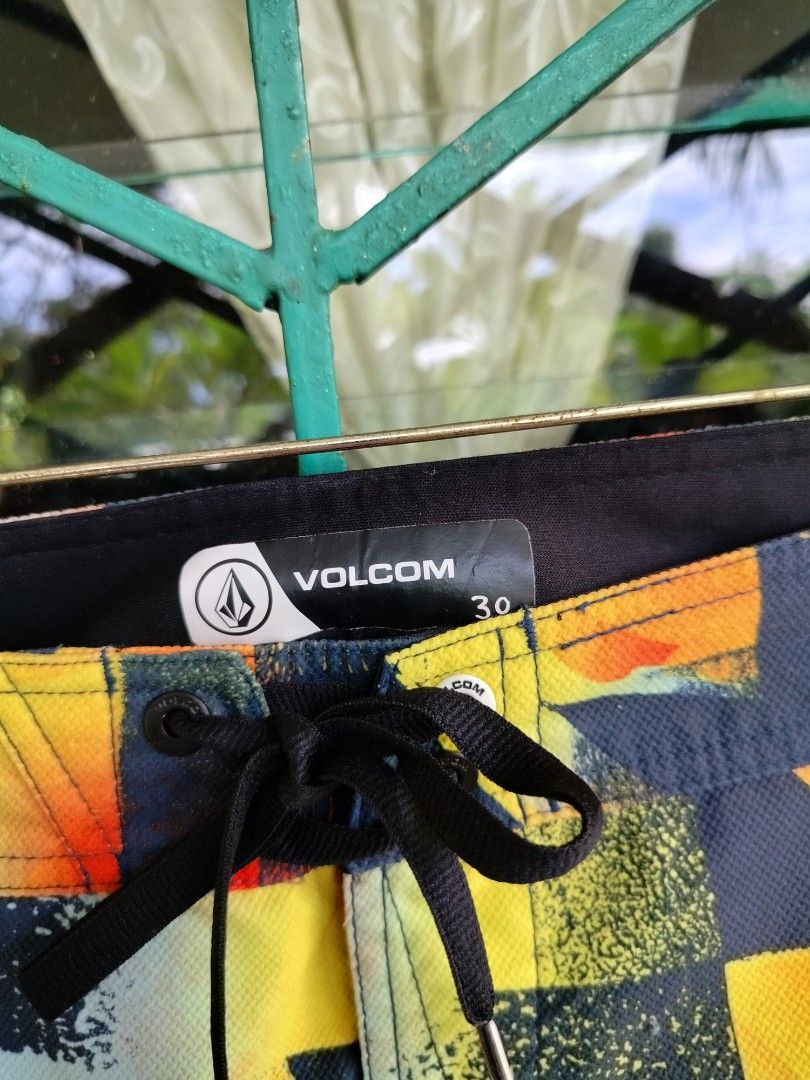 Volcom Men's Boardshorts Size 30 Multicolored (Category: Swim Trunks & Board Shorts) located in Manila. Submitted by gerald_quinto (Listing ID 1465470918, Image 3). Description: - Brand: Volcom - Size: 30 - Design: Vibrant multicolored geometric and abstract print - Features: Drawstring waistband with logo detail, back pocket with flap closure, and hem logo tag - Material: Lightweight, quick-dry fabric - Condition: Great for beach or pool use.