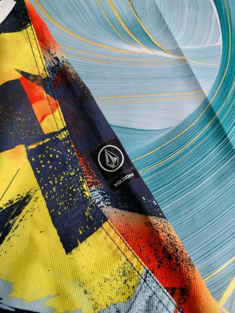 Volcom Multi-color Abstract Print Boardshorts Size 30 (Category: Swim Trunks & Board Shorts) located in Manila. Submitted by virgiliosa38485 (Listing ID 1465496072, Image 3). Description: - Brand: Volcom - Size: 30 (inner waistband tag) -Waist 30-32 -Length 19 - Color/Design: Bold abstract print in yellow, orange, and navy blue - Features: Front drawstring closure, back pocket with Volcom patch, and branded patch on the left leg - Condition/Style